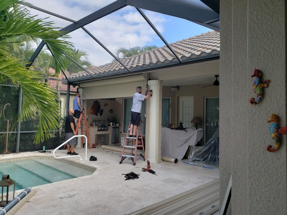 Technician servicing hurricane shutters